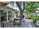 Relaxing patio with seating area under a large tree at 6005 Midnight Pass Rd # N8, Sarasota, FL 34242