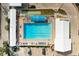 Overhead view of resort-style pool with lounge chairs and shade structures at 6005 Midnight Pass Rd # N8, Sarasota, FL 34242