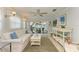 Relaxing sunroom with white sofa and access to the backyard at 6005 Midnight Pass Rd # N8, Sarasota, FL 34242