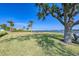 Expansive grassy lawn with tree and seating at 6005 Midnight Pass Rd # N8, Sarasota, FL 34242