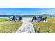 Waterfront patio with seating and firepit area at 6005 Midnight Pass Rd # N8, Sarasota, FL 34242