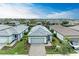 Single-story home with gray roof and paver driveway in a neighborhood at 6273 Winding Pine Dr, Nokomis, FL 34275