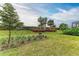 Landscaped backyard with lush greenery and mature trees at 6273 Winding Pine Dr, Nokomis, FL 34275
