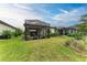 Spacious backyard features a screened patio and well-manicured lawn at 6273 Winding Pine Dr, Nokomis, FL 34275