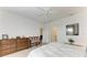 Well-lit bedroom with wooden dresser and cozy sitting bench at 6273 Winding Pine Dr, Nokomis, FL 34275
