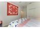 Serene bedroom with red quilt and built-in closet at 6273 Winding Pine Dr, Nokomis, FL 34275