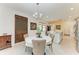 Round dining table with seating for four, in open concept space at 6273 Winding Pine Dr, Nokomis, FL 34275