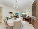 Bright dining room with round table and view of living area at 6273 Winding Pine Dr, Nokomis, FL 34275