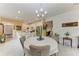 Open concept dining area with chandelier and kitchen views at 6273 Winding Pine Dr, Nokomis, FL 34275