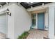 Front door with decorative lanterns and flamingo decor at 6273 Winding Pine Dr, Nokomis, FL 34275