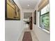 Bright hallway with tile flooring, leading to living areas at 6273 Winding Pine Dr, Nokomis, FL 34275