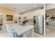 Modern kitchen with white cabinets, stainless steel appliances and large island at 6273 Winding Pine Dr, Nokomis, FL 34275