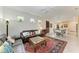 Open living space with leather couches and adjacent dining area at 6273 Winding Pine Dr, Nokomis, FL 34275
