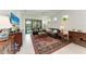 Living room features a leather sofa and access to a patio at 6273 Winding Pine Dr, Nokomis, FL 34275