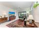Spacious living room with leather sofa and large TV at 6273 Winding Pine Dr, Nokomis, FL 34275