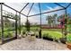 Relaxing screened patio with brick pavers and lush greenery at 6273 Winding Pine Dr, Nokomis, FL 34275