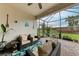 Cozy screened patio includes comfortable seating and backyard view at 6273 Winding Pine Dr, Nokomis, FL 34275
