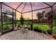 Peaceful screened patio offers scenic view, brick flooring and potted plants at 6273 Winding Pine Dr, Nokomis, FL 34275