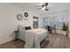 Bright bedroom with light blue bedding, wood floors, and a ceiling fan at 6902 22Nd W Ave, Bradenton, FL 34209