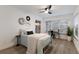 Bright bedroom with light blue bedding, wood floors, and a ceiling fan at 6902 22Nd W Ave, Bradenton, FL 34209