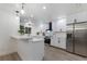 Modern white kitchen with stainless steel appliances and quartz countertops at 6902 22Nd W Ave, Bradenton, FL 34209