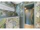 Stylish bathroom with walk-in shower and patterned walls at 7056 Hawks Harbor Cir, Bradenton, FL 34207