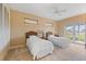 Guest bedroom with twin beds and access to patio at 7056 Hawks Harbor Cir, Bradenton, FL 34207
