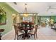 Elegant dining room with a round table and access to living room at 7056 Hawks Harbor Cir, Bradenton, FL 34207