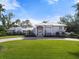 Grand waterfront home with circular driveway and manicured lawn at 7056 Hawks Harbor Cir, Bradenton, FL 34207