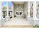 Elegant entryway with double doors, columns, and a tiled porch at 7056 Hawks Harbor Cir, Bradenton, FL 34207