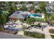 Aerial view of mid-century modern home with pool and lush landscaping at 711 Russell St, Longboat Key, FL 34228