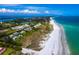 Aerial of beachfront property with condos and white sand beach at 711 Russell St, Longboat Key, FL 34228