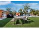 Outdoor dining area with pool and lush landscaping at 711 Russell St, Longboat Key, FL 34228