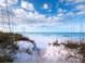 Path through dunes to beach with beautiful water views at 711 Russell St, Longboat Key, FL 34228