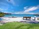 Relaxing beachfront view with boats and bench at 711 Russell St, Longboat Key, FL 34228