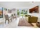 Modern dining area with glass table and green sofa at 711 Russell St, Longboat Key, FL 34228