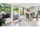 Bright dining room with glass table and chairs, leading to a patio at 711 Russell St, Longboat Key, FL 34228