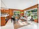 Living room with wood paneling, large windows, and a stylish sofa at 711 Russell St, Longboat Key, FL 34228