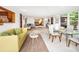 Open living space with green couch and glass dining table at 711 Russell St, Longboat Key, FL 34228