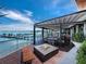 Outdoor patio with fire pit, wooden seating, and water views at 711 Russell St, Longboat Key, FL 34228