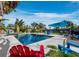 Relaxing pool area with colorful chairs and umbrella at 711 Russell St, Longboat Key, FL 34228