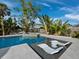 Inviting pool area with built-in seating and lush landscaping at 711 Russell St, Longboat Key, FL 34228