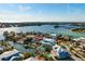 Aerial view of a beautiful coastal home with pool, surrounded by waterways, and a view of the ocean at 718 Key Royale Dr, Holmes Beach, FL 34217