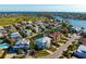 Aerial view of a coastal community featuring a home with a pool and boat dock on a waterway at 718 Key Royale Dr, Holmes Beach, FL 34217