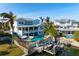 Exterior view of waterfront home featuring private pool, boat dock, and spacious outdoor entertaining area at 718 Key Royale Dr, Holmes Beach, FL 34217