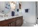 Bathroom featuring double vanities with marble countertops and modern fixtures at 718 Key Royale Dr, Holmes Beach, FL 34217