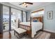 Bedroom with light blue walls, wood floors, and access to a balcony at 718 Key Royale Dr, Holmes Beach, FL 34217