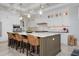 Spacious kitchen features an island with seating, stainless steel appliances, and marble countertops at 718 Key Royale Dr, Holmes Beach, FL 34217