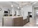 Kitchen island with marble counters, stainless dishwasher, and open view to the living room at 718 Key Royale Dr, Holmes Beach, FL 34217