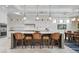 Bright kitchen features an island with seating, marble counters, and pendant lighting at 718 Key Royale Dr, Holmes Beach, FL 34217
